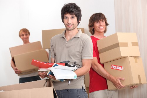Packed boxes and removal team preparing for local move