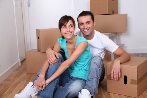 Professional movers handling household boxes and furniture in Greenwich