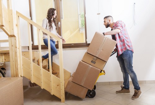 Packed moving boxes and protected furniture ready for a Greenwich house move