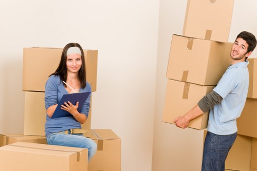 Professional movers loading furniture into a removal vehicle
